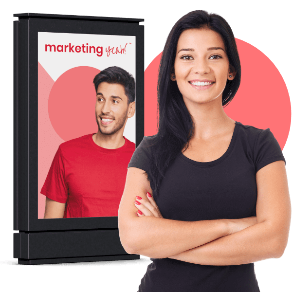 Marketing Yeah! team member in front of an outdoor advertising board